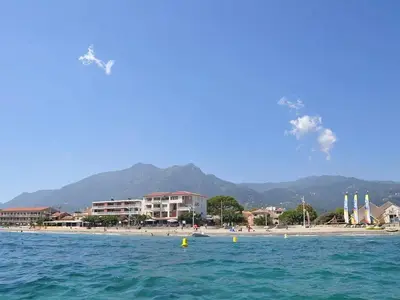 a view of a beach with buildings and the ocean at Studio accueillant à San-Nicolao avec vue mer, 27 m² in San-Nicolao