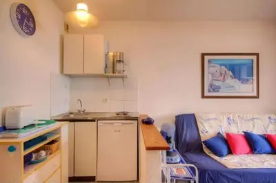 a living room with a couch and a kitchen at Studio accueillant à San-Nicolao avec vue mer, 27 m² in San-Nicolao