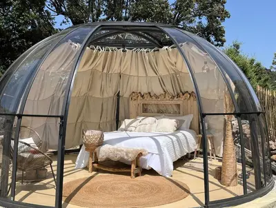 a bedroom in a dome tent with a bed in it at Dôme étoilé in Vallica