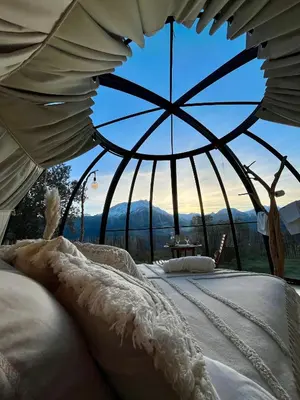 a bedroom with two beds with a view of the mountains at Dôme étoilé in Vallica