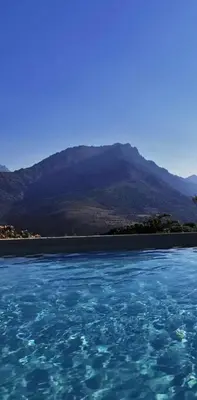 a large body of water with a mountain in the background at Dôme étoilé in Vallica
