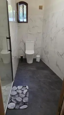 a bathroom with a toilet and a glass shower at Villa Propriano vue mer in Viggianello