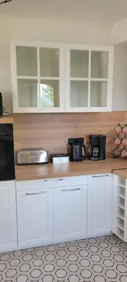 a kitchen with white cabinets and a counter top at Villa Propriano vue mer in Viggianello
