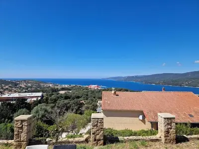 a house with a red roof and a view of the water at Villa Propriano vue mer in Viggianello