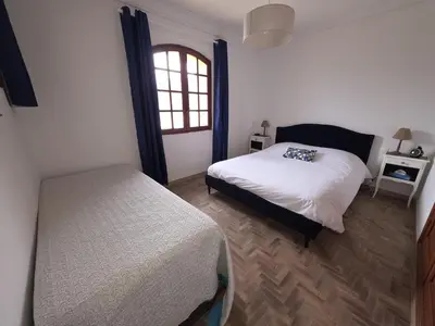 a bedroom with a bed and a window at Villa Propriano vue mer in Viggianello