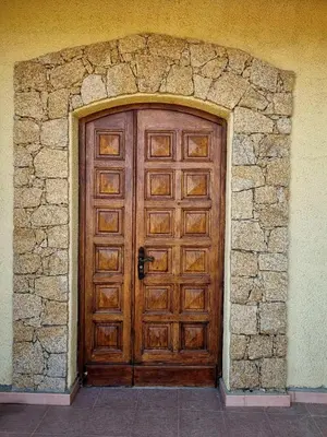 a large wooden door in a stone wall at Villa Propriano vue mer in Viggianello