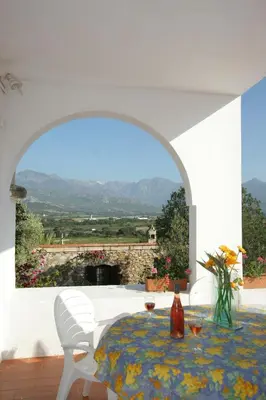 a dining room with a table and a view at 1st floor apartment in 18th century character house in Calvi
