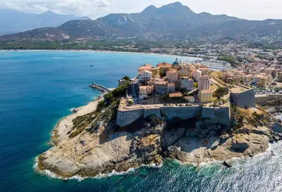 an aerial view of a village on a rocky island in the ocean at 1st floor apartment in 18th century character house in Calvi