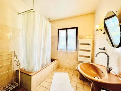 a bathroom with a tub and a sink and a shower at CasaCampanile in Olmeto