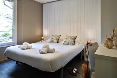 a bedroom with a large white bed with two pillows at Résidence & Hotel U Livanti ECOLABEL in Propriano