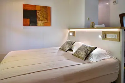 a bedroom with a large white bed with two pillows at Résidence & Hotel U Livanti ECOLABEL in Propriano