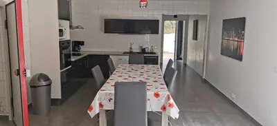 a kitchen with a table with a table cloth on it at Plain pied idéalement situé in Sainte-Lucie de Porto-Vecchio