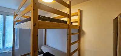 a bunk bed with a ladder in a room at Maison Quenza Corse-du-Sud in Quenza