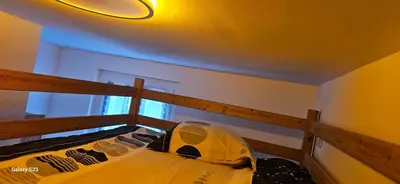 a bunk bed in a room with a light on the ceiling at Maison Quenza Corse-du-Sud in Quenza