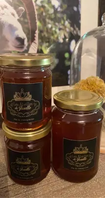 two jars of honey sitting on a table at Maison Quenza Corse-du-Sud in Quenza