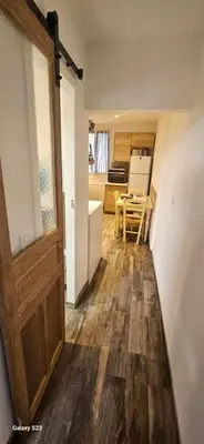 a room with a door and a kitchen with a table at Maison Quenza Corse-du-Sud in Quenza