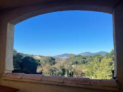 an open window with a view of the mountains at T2 sur hauteur de Porticcio avec vue sur la baie d Ajaccio in Porticcio