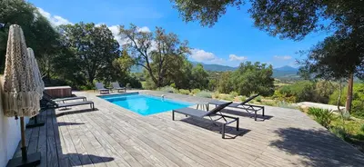 a house with a swimming pool and chairs next to it at Hôtel Résidence de standing Casa Pian d'Olmo in Olmiccia