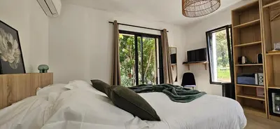 a bedroom with a large bed and a window at Hôtel Résidence de standing Casa Pian d'Olmo in Olmiccia