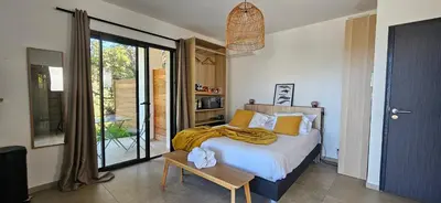 a bedroom with a bed with pillows on it at Hôtel Résidence de standing Casa Pian d'Olmo in Olmiccia