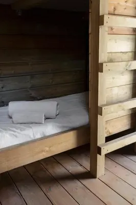 a wooden bunk bed with two white towels on it at Relais - U Machjonu in Tolla