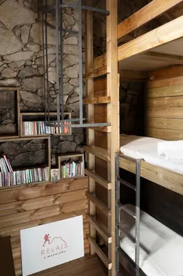 a room with a bunk bed and a book shelf at Relais - U Machjonu in Tolla