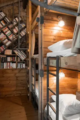 a room with three bunk beds in a cabin at Relais - U Machjonu in Tolla