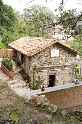 a stone building with a sign on it at Relais - U Machjonu in Tolla