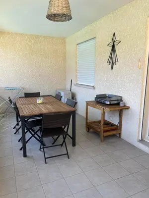 a dining room with a wooden table and chairs at Appartement Cosy à Lecci , Porto Vecchio in Lecci