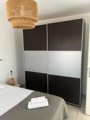 a bedroom with a bed with two towels on it at Appartement Cosy à Lecci , Porto Vecchio in Lecci