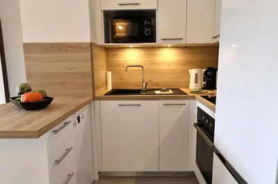a kitchen with a sink and a microwave at La Parenthèse Corse - T2 cabine vue mer in Pianottoli-Caldarello