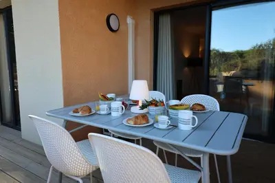 a blue table with plates of food on it at La Parenthèse Corse - T2 cabine vue mer in Pianottoli-Caldarello
