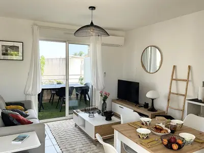 a living room with a couch and a table at Appartement cosy avec wifi en bord de mer in Poggio-Mezzana