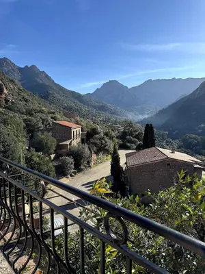 a view of a road with mountains in the background at Résidence Hôtelière CASA DI BABBÒ, Porto in Porto Ota