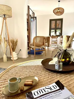 a living room with a table with a cup of coffee at Résidence Hôtelière CASA DI BABBÒ, Porto in Porto Ota