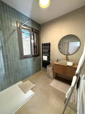 a bathroom with a sink and a mirror and a tub at Résidence Hôtelière CASA DI BABBÒ, Porto in Porto Ota