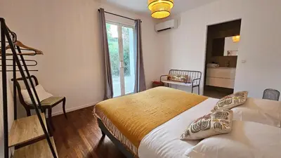 a bedroom with a bed and a chair and a window at Maison de Maître Albitru - Domaine Romella - Piscine - Vue Golfe St-Florent in Vallecalle