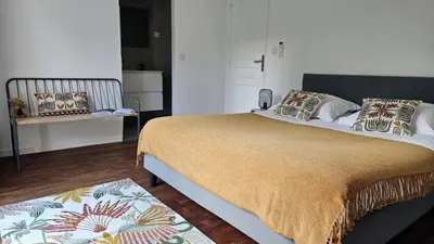 a bedroom with a bed and a bench in a room at Maison de Maître Albitru - Domaine Romella - Piscine - Vue Golfe St-Florent in Vallecalle