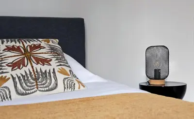 a bedroom with a bed and a microphone on a night stand at Maison de Maître Albitru - Domaine Romella - Piscine - Vue Golfe St-Florent in Vallecalle