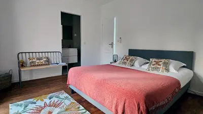 a bedroom with a large bed with a red blanket at Maison de Maître Albitru - Domaine Romella - Piscine - Vue Golfe St-Florent in Vallecalle