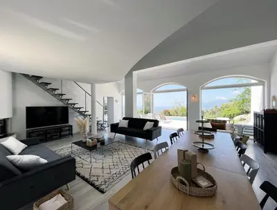a living room with a couch and a table at Maison de Maître Albitru - Domaine Romella - Piscine - Vue Golfe St-Florent in Vallecalle