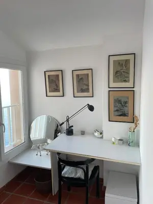 a white desk with a lamp and a chair at Penthouse Amazing View in Bonifacio