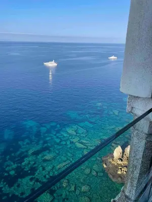 a view of the ocean with two boats in the water at Penthouse Amazing View in Bonifacio