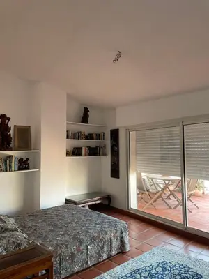 a bedroom with a bed and a sliding glass door at Penthouse Amazing View in Bonifacio