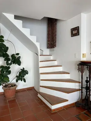 a staircase in a house with a potted plant at Penthouse Amazing View in Bonifacio