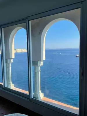 a view of the ocean from a window at Penthouse Amazing View in Bonifacio