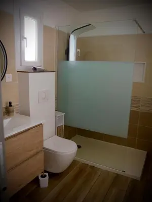 a bathroom with a toilet and a sink and a shower at Entre mer et montagne in Peri