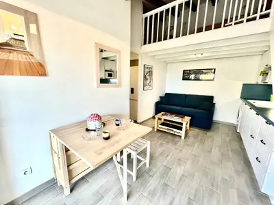 a living room with a table and a couch at Appartement Studio Porticcio Paesolu 313 in Porticcio