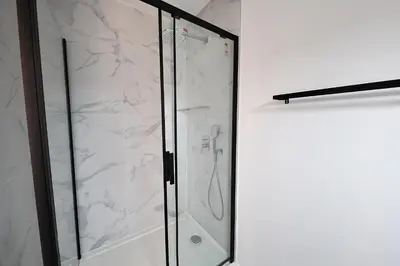 a shower with a glass door in a bathroom at Le Shetland - T4 spacieux bord de mer et piscine in Pianottoli-Caldarello