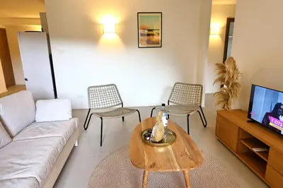 a living room with a couch and a table and chairs at Le Shetland - T4 spacieux bord de mer et piscine in Pianottoli-Caldarello